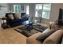 Spacious living room with ample natural light and stylish furniture at 1139 Euclid Rd, Venice, FL 34293