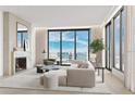 Spacious living room with fireplace and stunning water views at 223 Golden Gate Pt # 3A, Sarasota, FL 34236