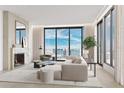 Spacious living room with city views and fireplace at 223 Golden Gate Pt # 4C, Sarasota, FL 34236