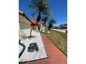 Home exterior featuring brick walkway with bright stone landscaping and beautiful palm trees at 4989 Clubview E Ct, Bradenton, FL 34203