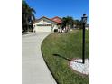Well-manicured lawn and landscaped front yard with stone accents lead to this lovely home at 4989 Clubview E Ct, Bradenton, FL 34203
