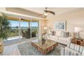 Bright living room with water views and cozy seating at 280 Hidden Bay Dr # 403, Osprey, FL 34229