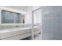 Modern bathroom with double vanity and blue tile at 2170 Robinhood Street # A3-306, Sarasota, FL 34231