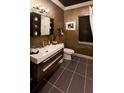 Modern bathroom with dark-toned vanity and tile floors at 640 N Owl Dr, Sarasota, FL 34236
