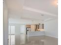 Open floor plan combining kitchen and living areas at 6009 White Mangrove Ln, Bradenton, FL 34210