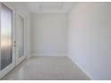 Bright, empty room with double doors and tile floors at 6009 White Mangrove Ln, Bradenton, FL 34210