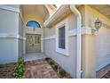 Inviting entryway with a light green door and a brick walkway at 4006 Caddie E Dr, Bradenton, FL 34203