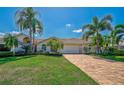 House exterior showcasing a brick paver driveway and palm trees at 4006 Caddie E Dr, Bradenton, FL 34203