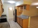 Kitchen with granite countertops and wood cabinets at 3360 S Osprey Ave # 102B, Sarasota, FL 34239