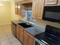 Kitchen with granite countertops and stainless steel appliances at 3360 S Osprey Ave # 102B, Sarasota, FL 34239