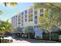 Front view of yellow condo building with palm trees at 915 Seaside Dr # 312 Weeks 32-33, Sarasota, FL 34242