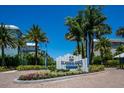 One Particular Harbour Marina Walk entrance sign with landscaping at 376 Aruba Cir # 301, Bradenton, FL 34209