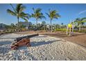 Community playground with a sandy play area and modern equipment at 376 Aruba Cir # 301, Bradenton, FL 34209