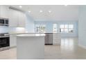 Modern kitchen featuring white cabinets, a kitchen island, and stainless steel appliances at 3426 79Th Street W Cir # 202, Bradenton, FL 34209