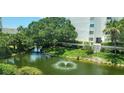 Relaxing pond view with fountain and lush landscaping at 1046 W Peppertree Ln # 115B, Sarasota, FL 34242