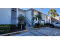 Modern condo building with parking and lush landscaping at 1046 W Peppertree Ln # 115B, Sarasota, FL 34242