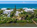 Waterfront home nestled amongst tropical foliage, offering a private dock at 426 N Casey Key Rd, Osprey, FL 34229
