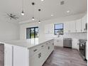 Modern kitchen with white cabinets, quartz countertops, and stainless steel appliances at 200 Redwood Rd, Rotonda West, FL 33947