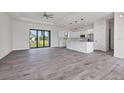 Open-concept living area with gray tile floors and a view of the kitchen at 200 Redwood Rd, Rotonda West, FL 33947