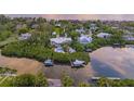 Luxury waterfront home with private dock and boat lifts, offering stunning sunset views at 6680 Gulf Of Mexico Dr, Longboat Key, FL 34228