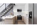 Modern kitchen with marble countertops and stainless steel appliances at 2170 Robinhood Street # C1-312, Sarasota, FL 34231
