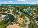 Bird's-eye view showcasing canal-front property, landscaping, and neighborhood context at 568 Venice Ln, Sarasota, FL 34242