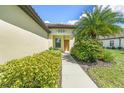 House exterior with walkway, landscaping and palm tree at 243 Cassano Dr, Nokomis, FL 34275