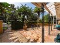 Relaxing side patio with stone flooring and lush landscaping at 1713 North Dr, Sarasota, FL 34239