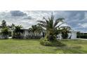 Single-story home with white exterior at 676 Key Royale Drive, Holmes Beach, FL 34217