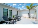 Inviting front patio with two gray adirondack chairs, perfect for relaxing at 676 Key Royale Drive, Holmes Beach, FL 34217