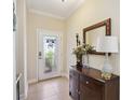 Entryway with a dark wood console table and mirror at 27855 Arrowhead Cir, Punta Gorda, FL 33982