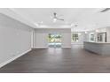 Open living room with tile floors and view of the backyard at 214 Lime Tree Park, Rotonda West, FL 33947