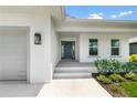 Welcoming house entrance with steps leading to the front door at 214 Lime Tree Park, Rotonda West, FL 33947