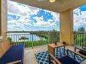 Relaxing balcony seating area showcases a stunning view of the water and beautiful Florida sky at 611 Riviera Dunes Way # 308, Palmetto, FL 34221