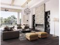 Bright and airy living room featuring a stone fireplace, high ceilings, and expansive views of the canal at 558 Venice Ln, Sarasota, FL 34242