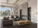 Comfortable living room area with a stone fireplace, chic lighting, and comfortable furniture at 558 Venice Ln, Sarasota, FL 34242