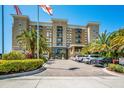 Condo building exterior with palm trees and parking at 1064 N Tamiami Trl # 1219, Sarasota, FL 34236