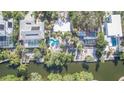 Aerial view of waterfront homes with private pools and lush landscaping at 451 Avenida De Mayo, Sarasota, FL 34242