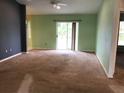 Living room with sliding glass doors to backyard at 1562 Jakway Rd, North Port, FL 34288