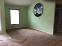 Spacious living room with light walls and carpeting at 1562 Jakway Rd, North Port, FL 34288