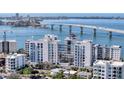 Aerial view of a modern waterfront building under construction with luxurious amenities at 223 Golden Gate Point # 8A, Sarasota, FL 34236