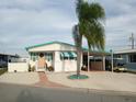 Cute florida mobile home with palm tree and golf cart at 4802 Brae Burn Ave, Sarasota, FL 34234