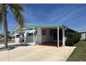 Charming single-story home with a covered carport and manicured landscaping offers curb appeal at 4802 Brae Burn Ave, Sarasota, FL 34234