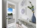 Bright entryway with stylish decor, a console table with artwork, and a view of the exterior at 1709 N Tamiami Trl # 403, Sarasota, FL 34234