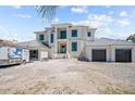 Expansive two-story home showcasing modern architecture with a spacious three-car garage and light gray roofing at 3621 San Remo Ter, Sarasota, FL 34239