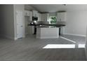 Modern kitchen with island and white cabinets at 5655 Hale Rd, Venice, FL 34293