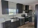 Modern kitchen with stainless steel appliances and dark cabinets at 4772 Duncan Rd, Punta Gorda, FL 33982