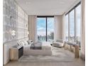 Bright bedroom with water views and sitting area at 223 Golden Gate Point # 9C, Sarasota, FL 34236