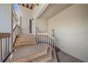 Front door with tile entrance and wooden stairway at 1654 Starling Dr # 201, Sarasota, FL 34231