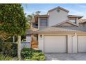 Charming home featuring a two-car garage, brick-paved driveway and walkway leading to the front door at 1654 Starling Dr # 201, Sarasota, FL 34231